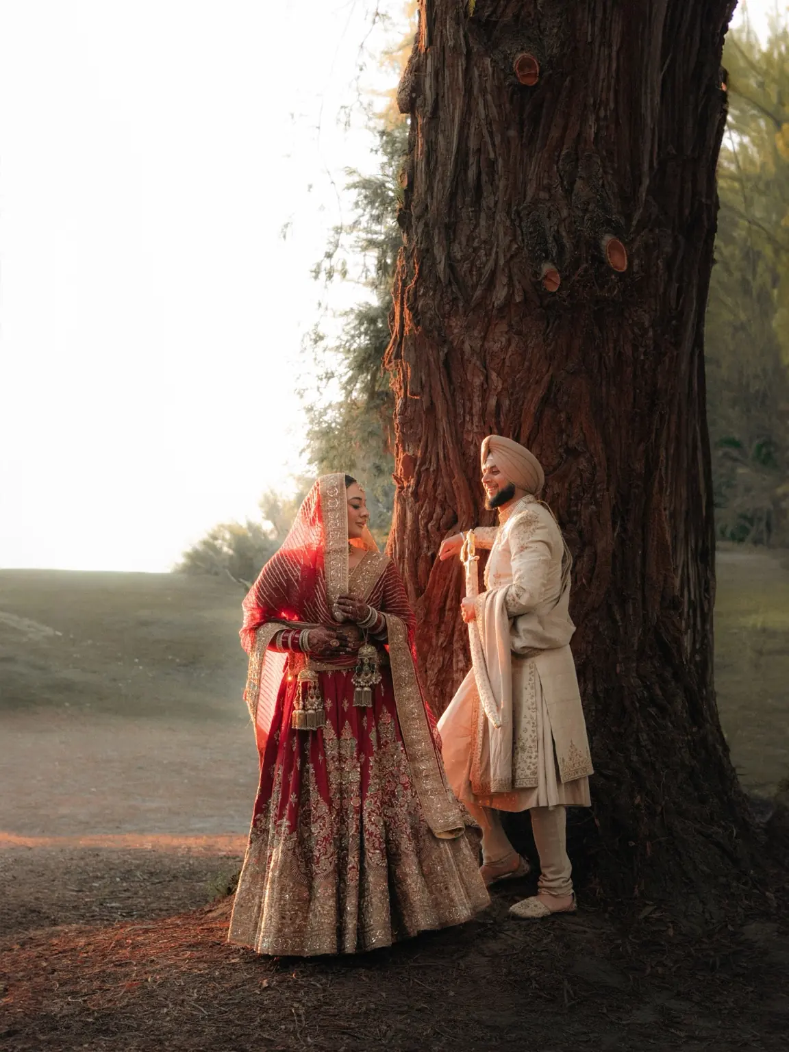 Warm evening light around Ramandeep and Jaskaran beneath a tree