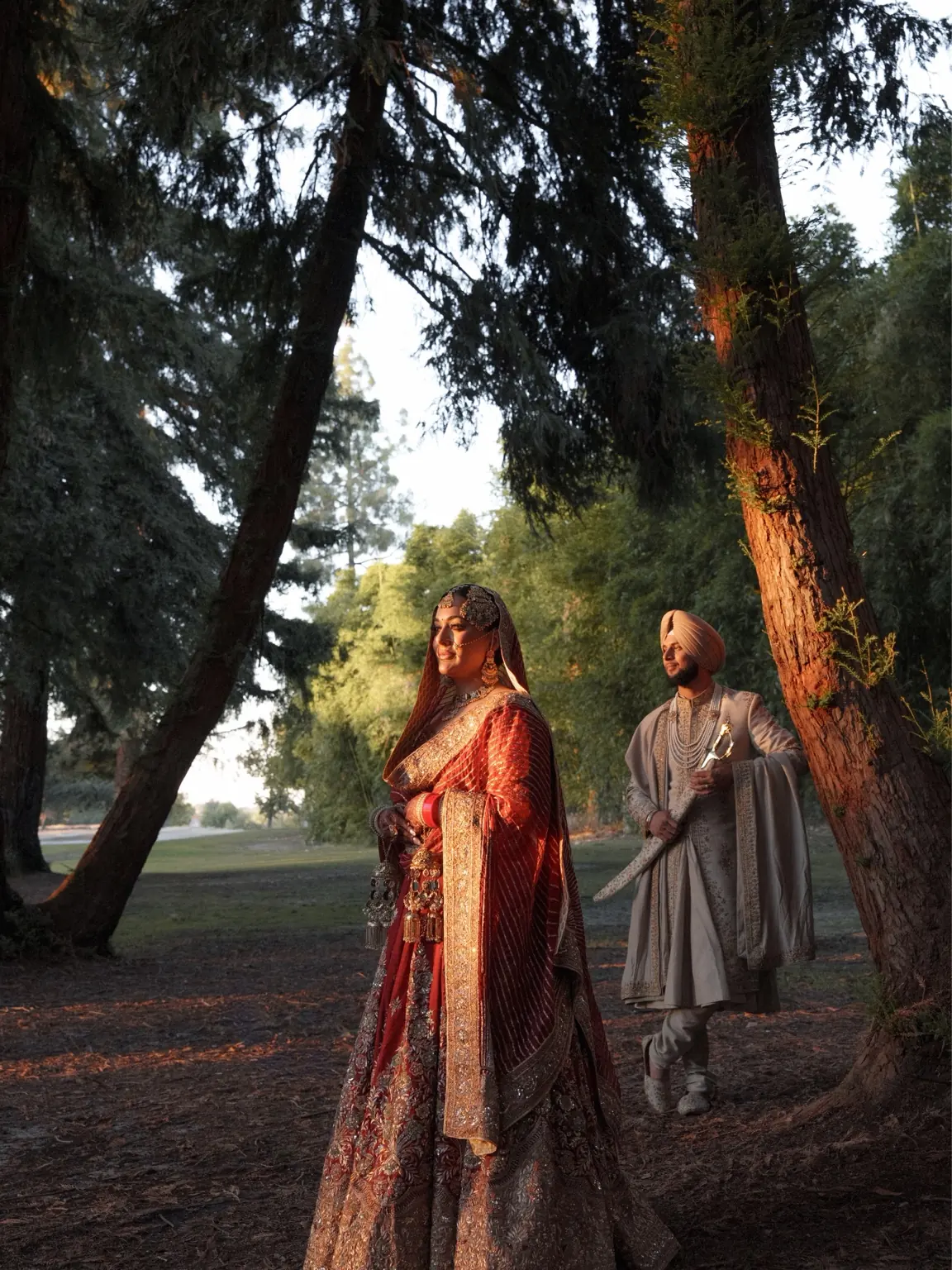 Ramandeep and Jaskaran framed by trees and golden light