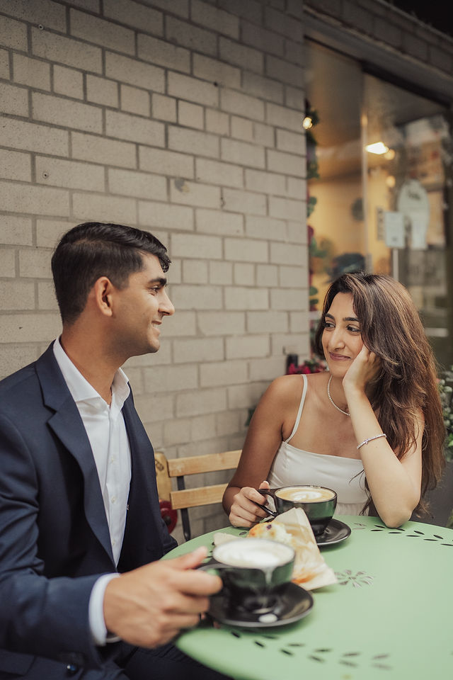Richa and Shahil sharing a moment at an outdoor café table