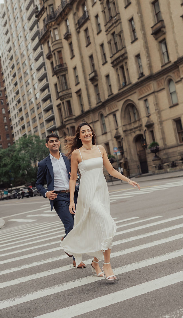 Richa and Shahil crossing a Manhattan street hand in hand