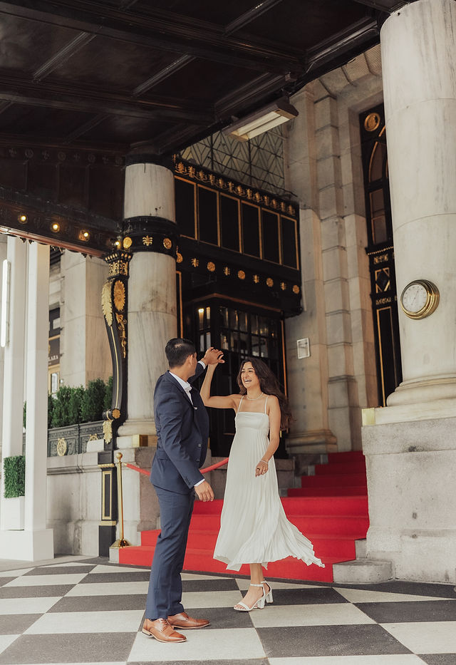 Richa and Shahil sharing a playful step outside a city building