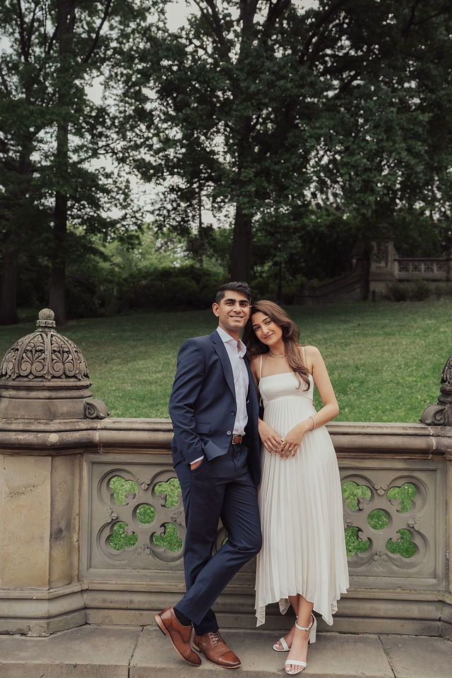 Richa and Shahil standing together on a leafy park terrace
