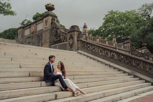 Richa and Shahil seated together on the wide park steps
