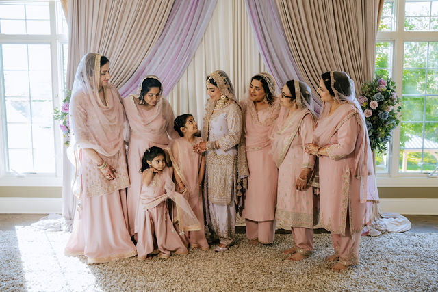 Sakhi with family in blush wedding attire