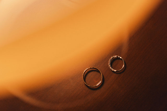 Their wedding rings in warm golden light