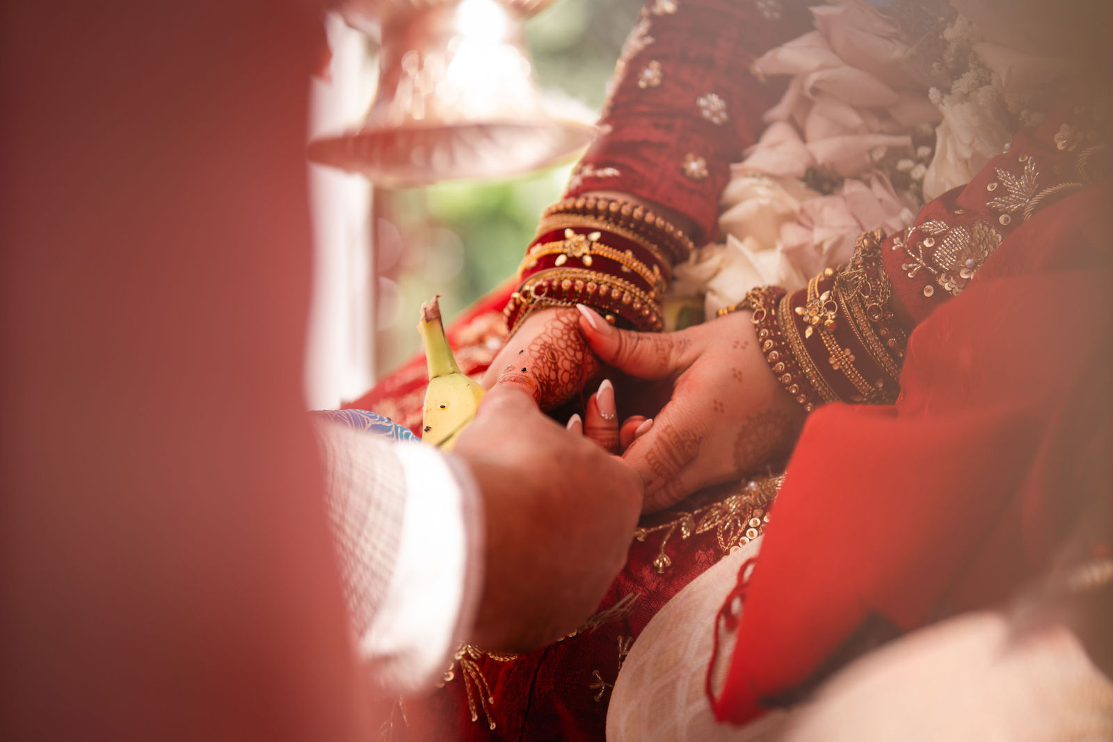 Hands meeting during Shayal and Anup’s wedding ceremony