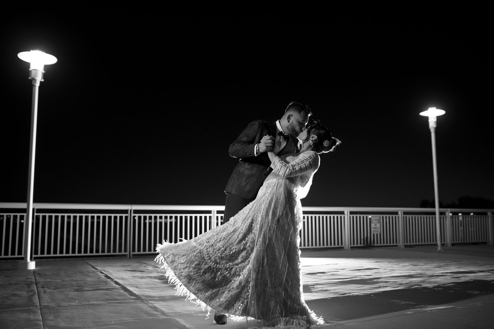 Shayal and Anup dancing on a terrace at night in black and white
