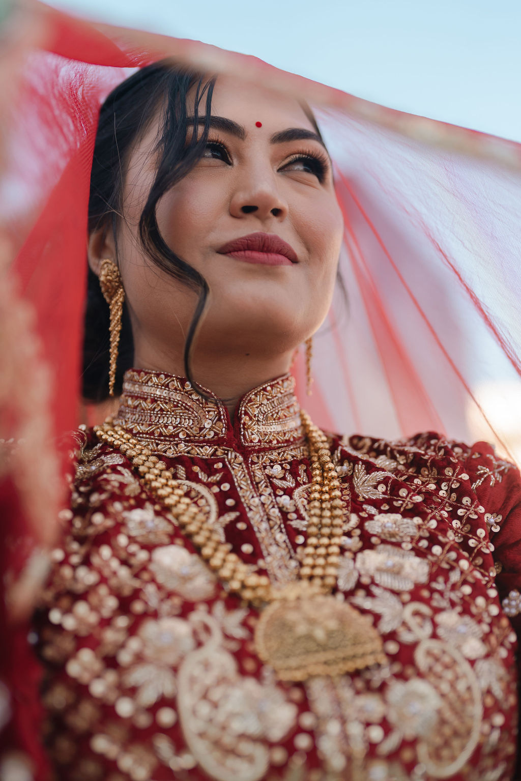 Close bridal portrait of Shayal beneath her veil