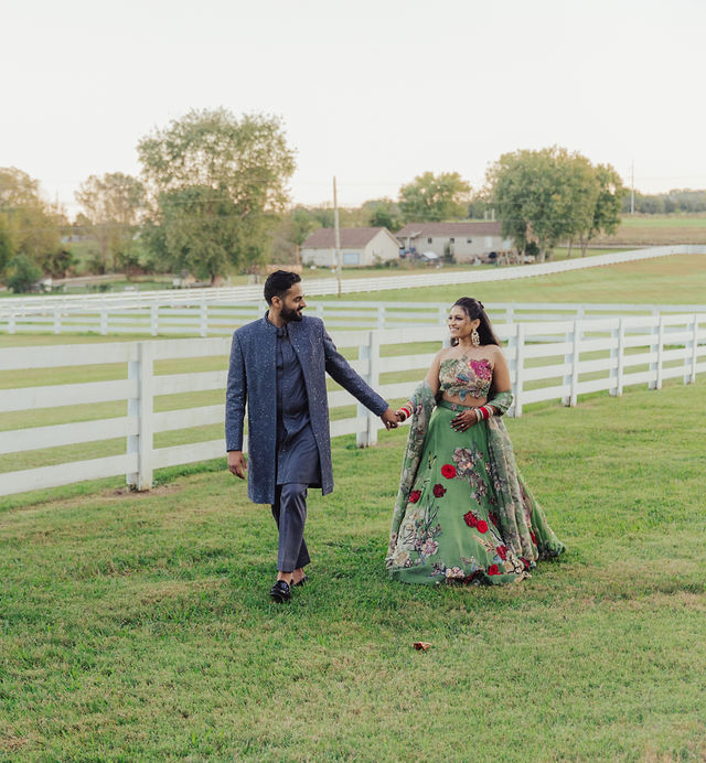 The couple walking together through the fields