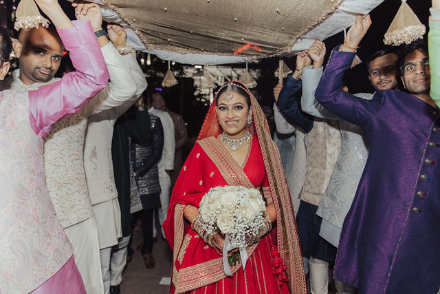 Shrusti entering beneath her bridal canopy