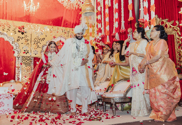 The couple surrounded by petals and family