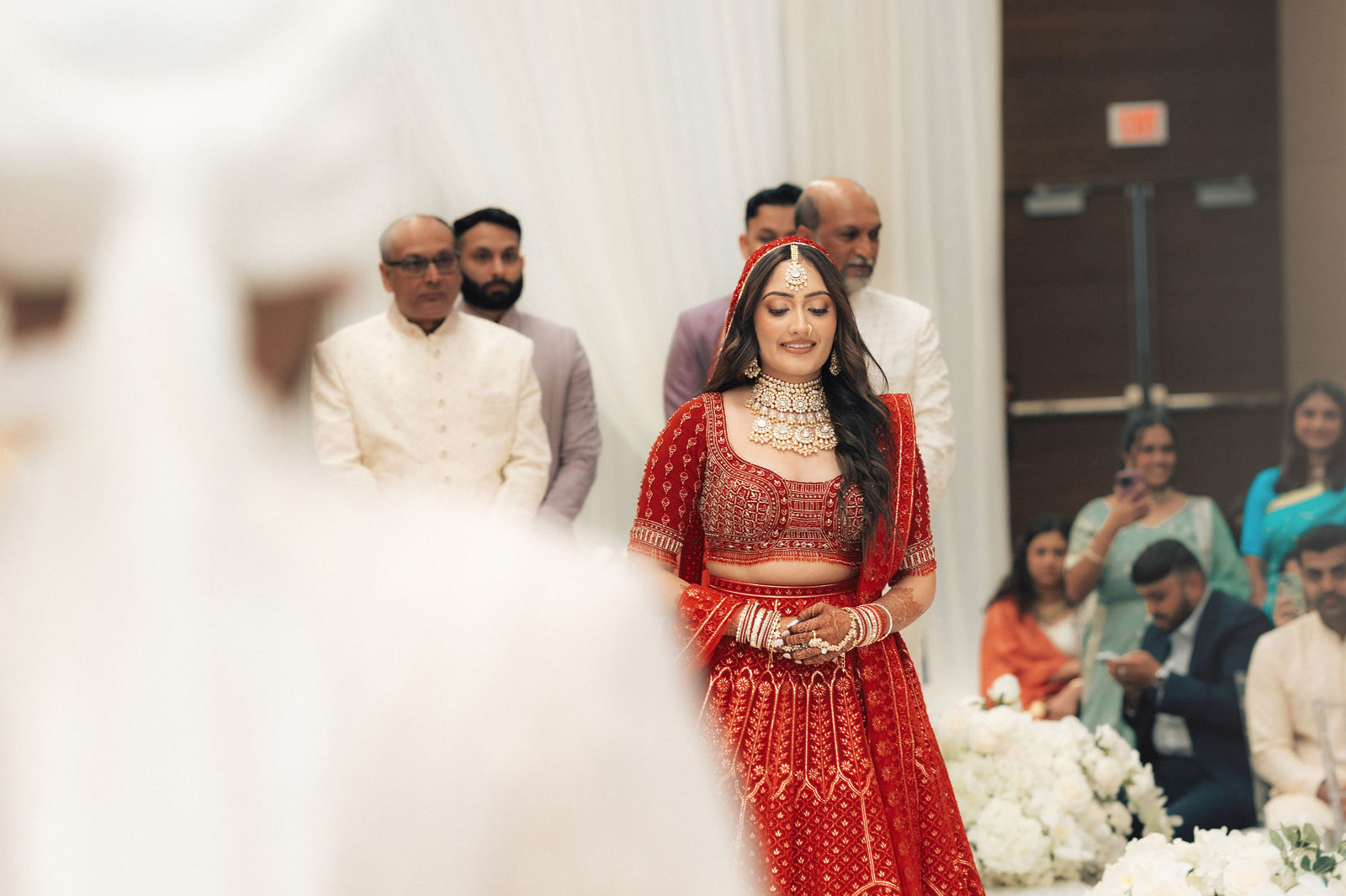 Sonalii entering the ceremony with family and guests around her