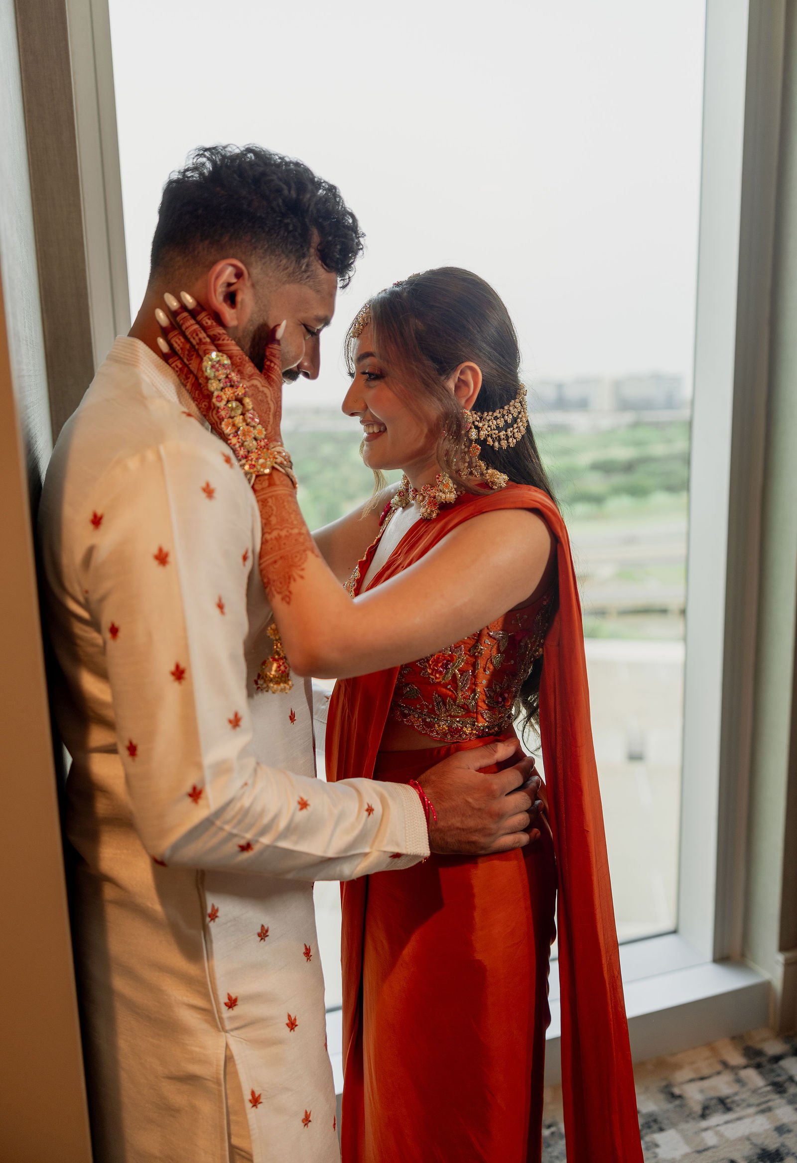Sonalii and Ravin sharing a quiet portrait by the window before Haldi