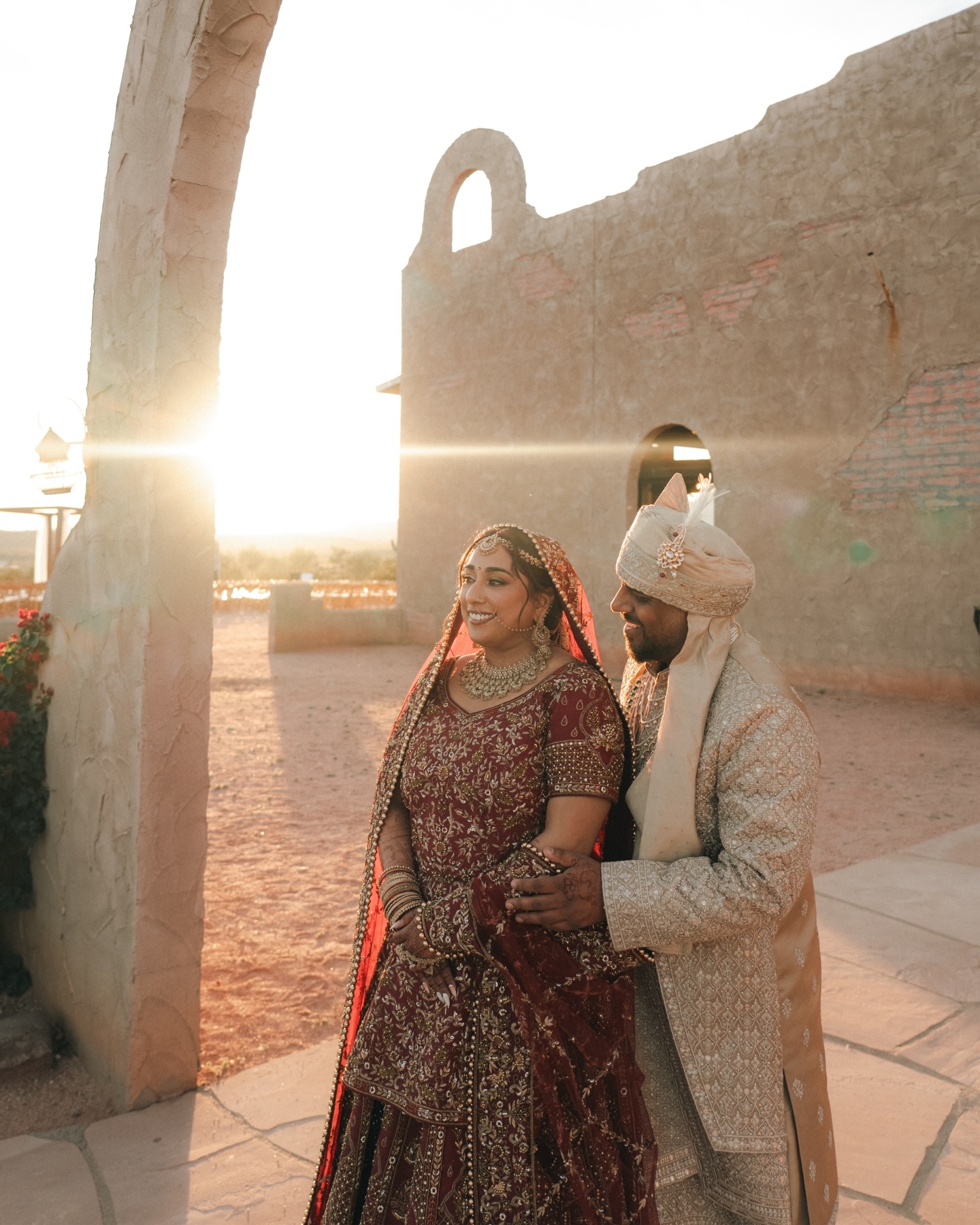 Shachi and Roni in a close portrait beside the arch