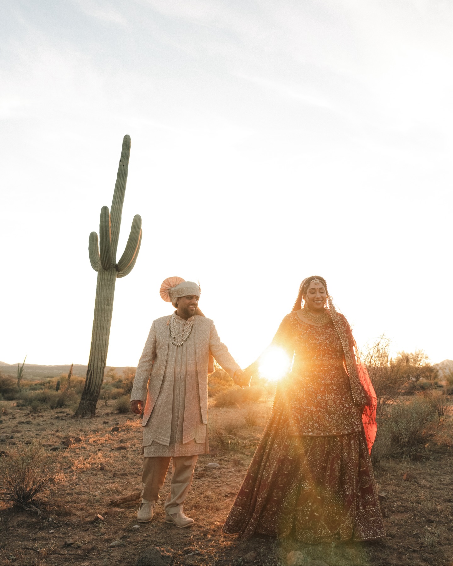 Shachi and Roni walking hand in hand at golden hour
