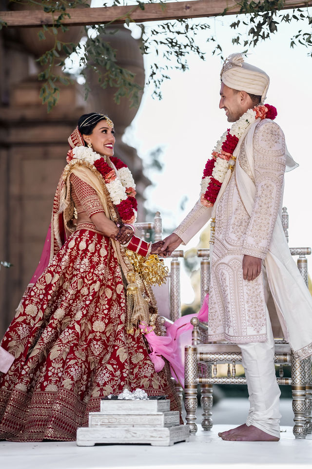 Vishalli and Lewis together with garlands during their Hindu wedding ceremony