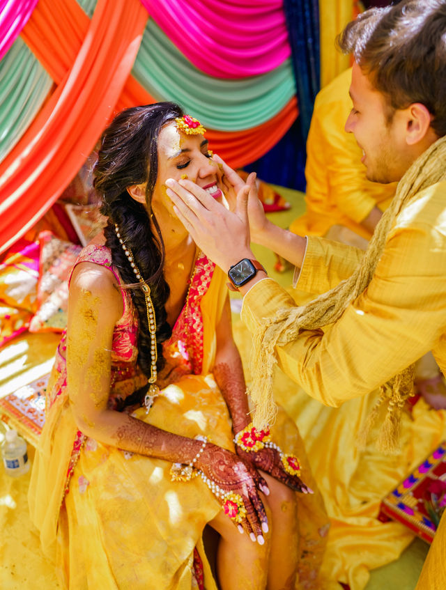 Vishalli and Lewis sharing a playful moment at their Haldi