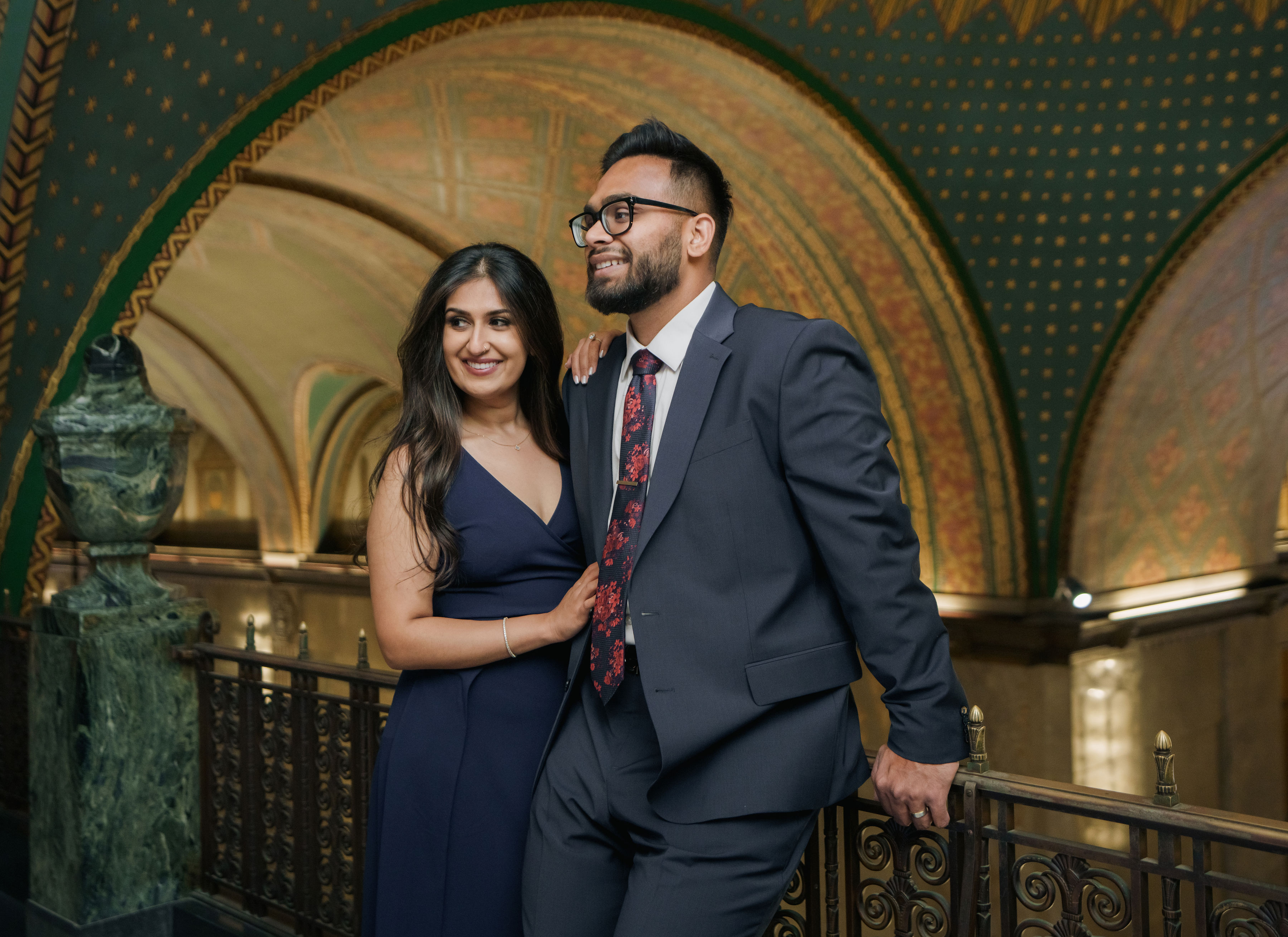 Vidhi and Mayank beneath an ornate arch