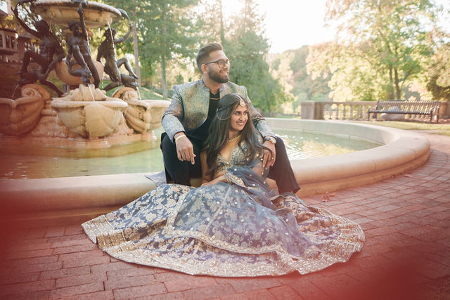 Vidhi and Mayank together beside a garden fountain