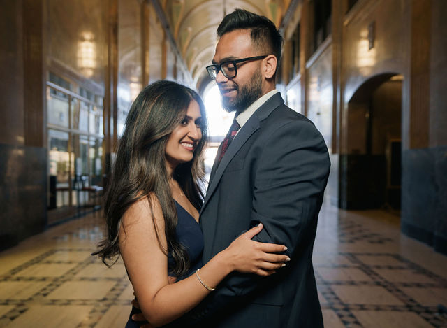 Vidhi and Mayank in a close portrait beneath warm interior light