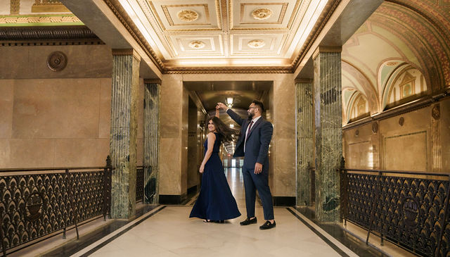 Vidhi and Mayank framed by the hall's archways
