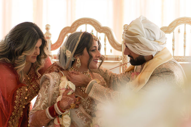 Nirali smiles with family beside Varun during the wedding