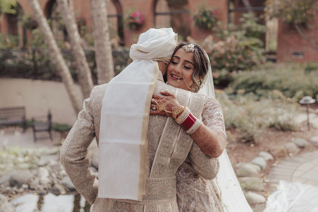 Nirali embraces Varun in the courtyard