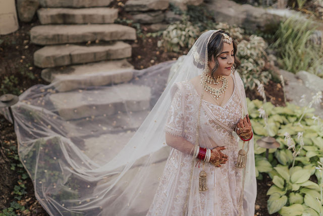 Nirali’s bridal portrait with her veil flowing behind her