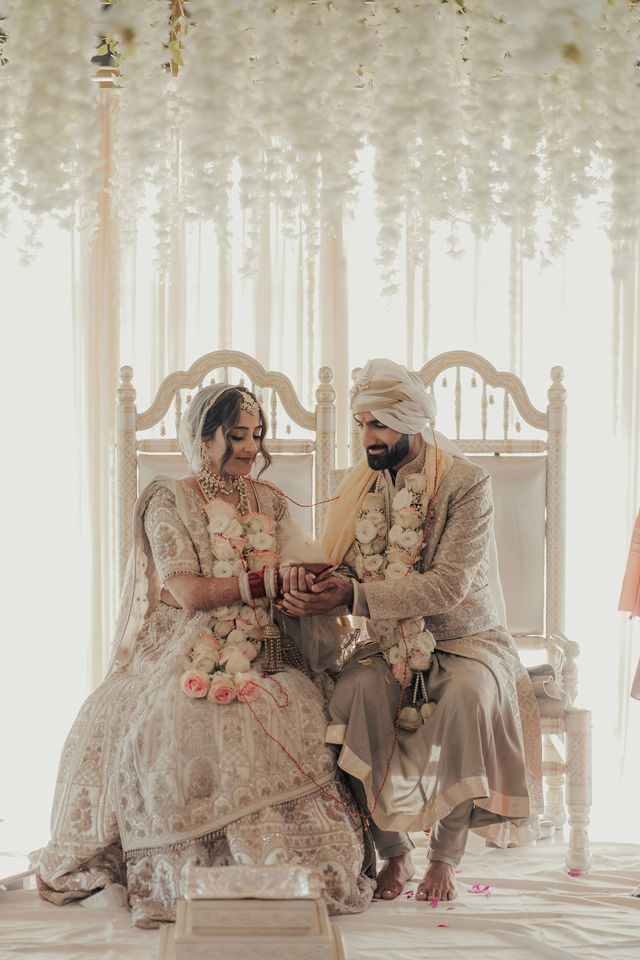 Varun and Nirali seated together during their ceremony