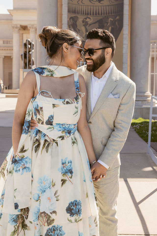 Yash and Parth smiling together outside the Palace of Fine Arts