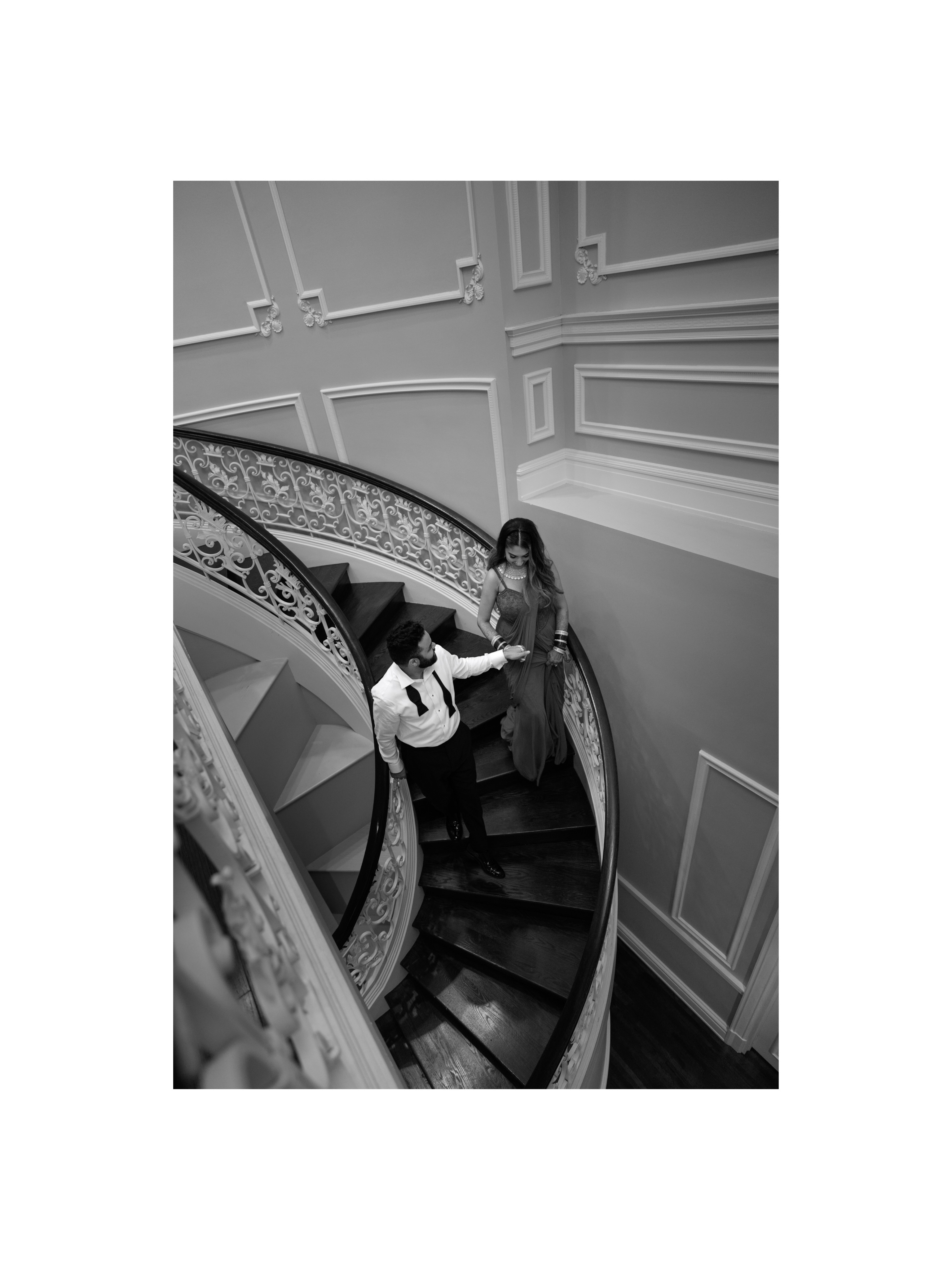 Yash and Parth on the staircase in a black and white portrait