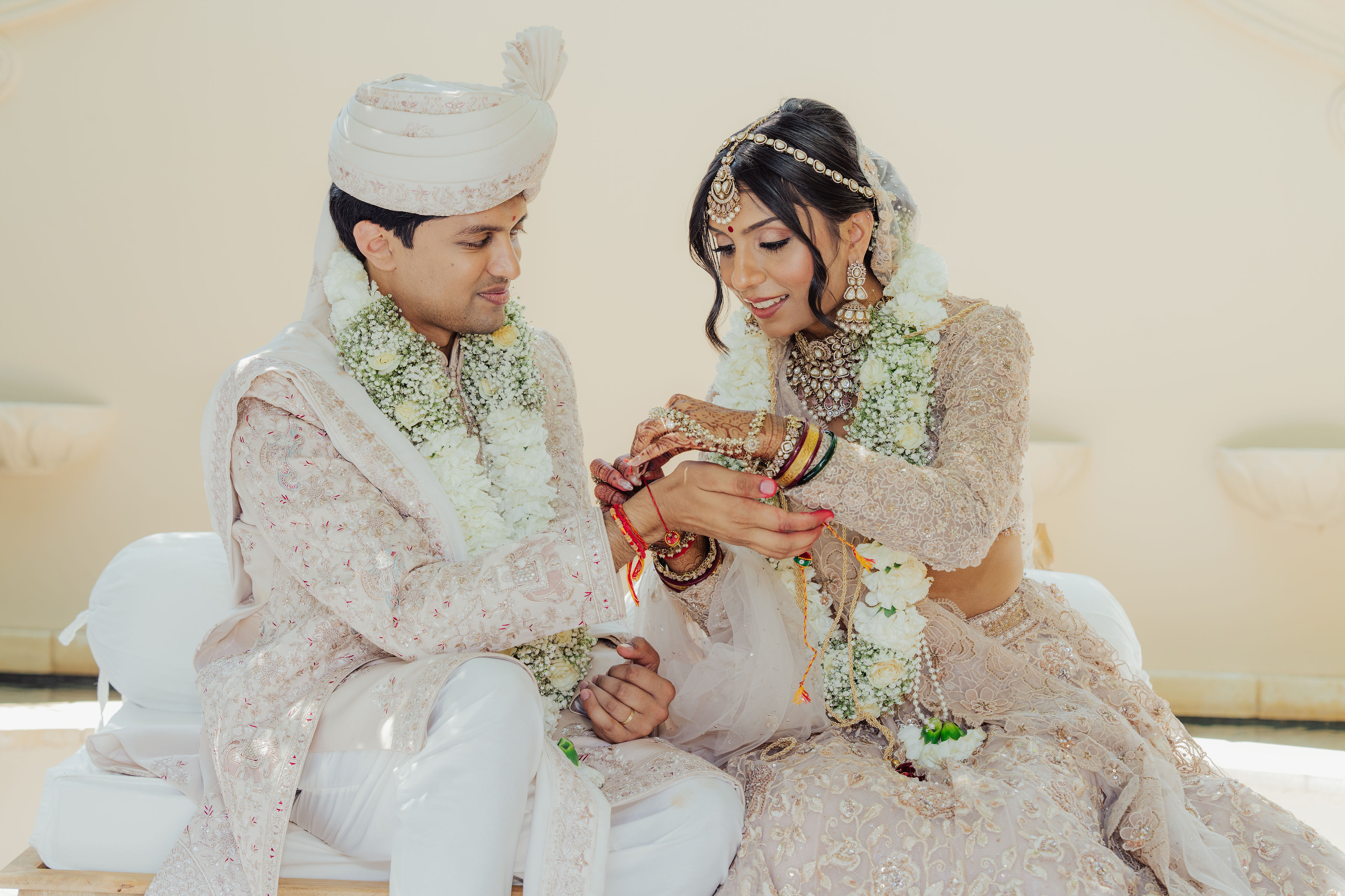 Zohal and Jairam seated together during their Gujarati wedding ceremony