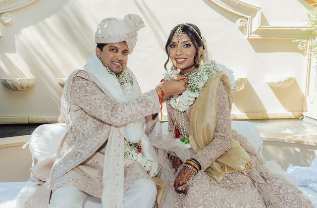 Zohal and Jairam seated together during their wedding ceremony