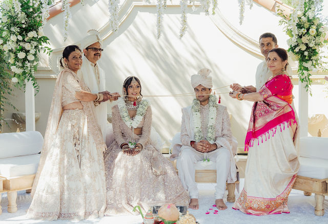 Zohal and Jairam with family during a ceremony ritual