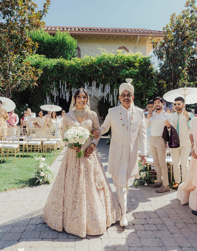 Zohal walking toward her wedding ceremony with family